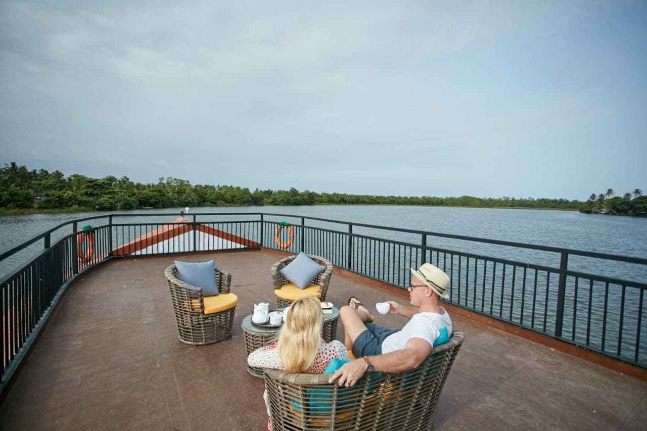 couple having a tea session on upper deck of flow 1 - Charters by Debug Auto Exclusive