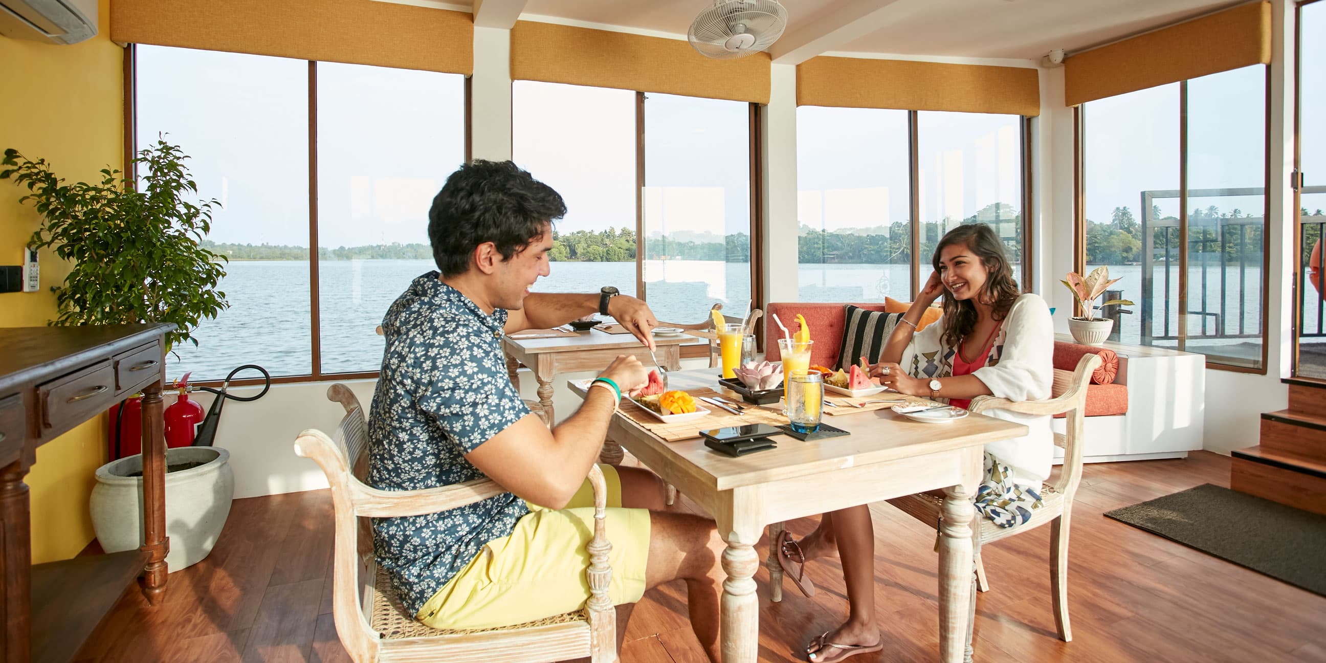 a couple having lunch in flow 1 with lake view - Charters by Debug Auto Exclusive